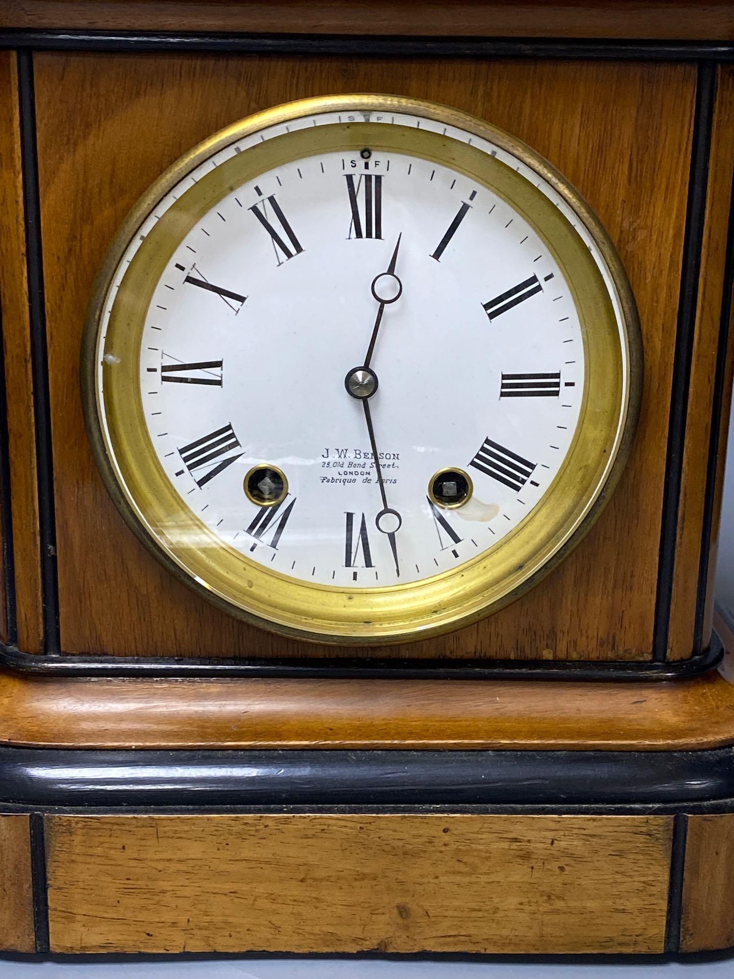 A walnut cased and ebonised mantel clock retailed by JW Benson, French movement striking on a gong, height 27cm